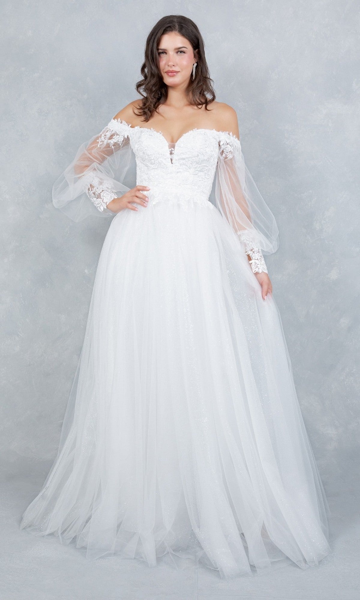A woman poses in the Cinderella Couture 4233 long formal dress—an off-the-shoulder white gown featuring an embroidered bodice, long sheer sleeves, and a full tulle skirt—against a light gray textured background.
